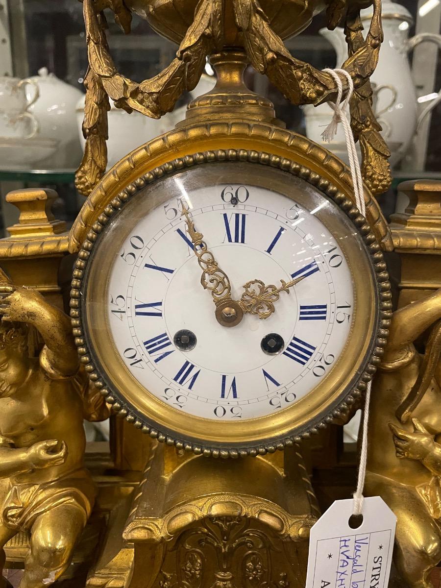 19th century bronze gilded clock. 46w x 46h cm (without wooden console) 