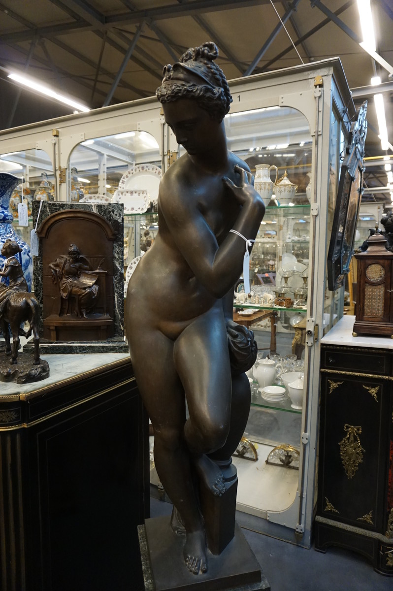 Big bronze nude on marble column