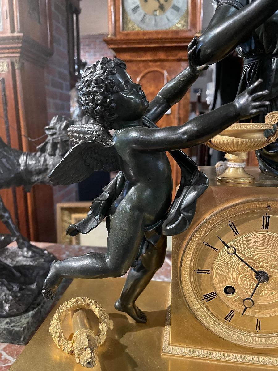 Bronze gilded and patinated Empire clock