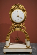 Directoire style Clock in gilded bronze and marble, France last part 18th C.