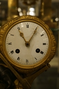 Directoire style Porte faix clock in gilded bronze, France around 1800