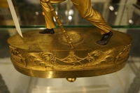 Directoire style Porte faix clock in gilded bronze, France around 1800