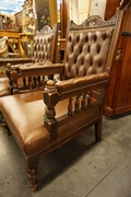 Edwardian pair of armchairs in oak with leather, early 20th C.