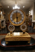 Empire style clock in gilded bronze, France 19th century
