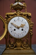 Louis XVI style Clock set in gilded bronze, France 2nd half 20th C.