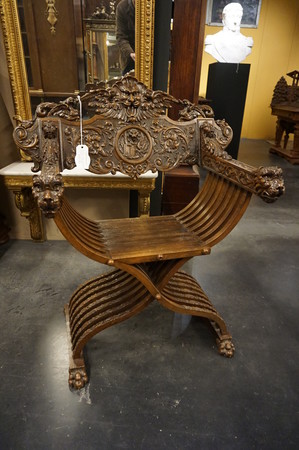 Walnut carved Savonarola armchair